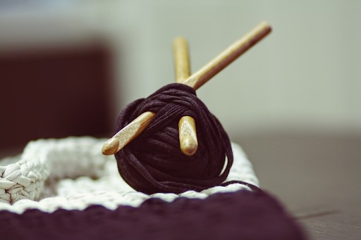 Close up of inline crochet hook and brown yarn