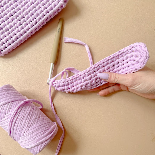 close up of crochet project pink yarn