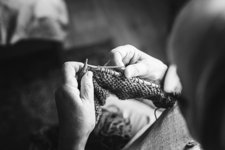 black and white picture of a senior woman knitting