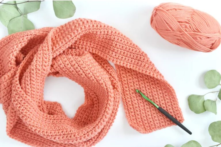 close up of crochet scarf in salmon pink