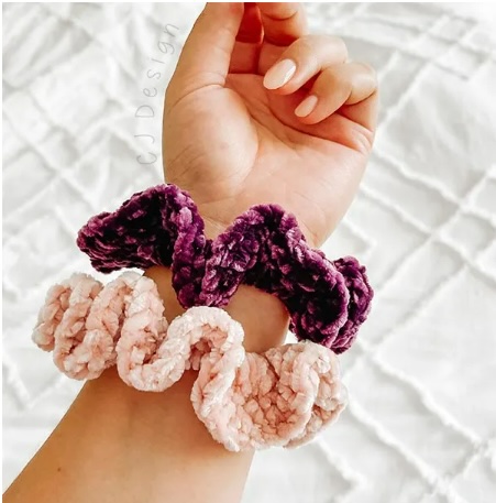 close up of pink and purple corchet scrunchie on womans arm