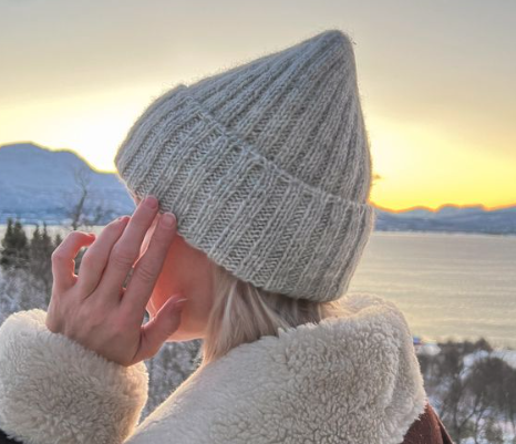 knitted gray hat on woman with winter background