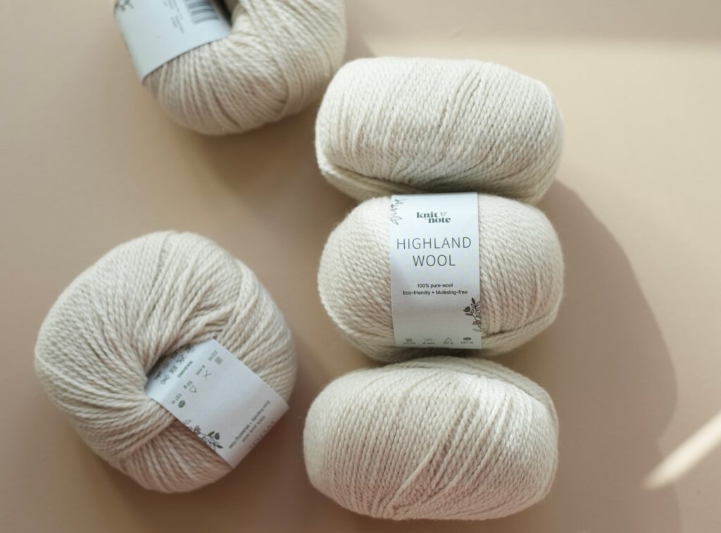 close up of creme colored highland wool yarn skeins