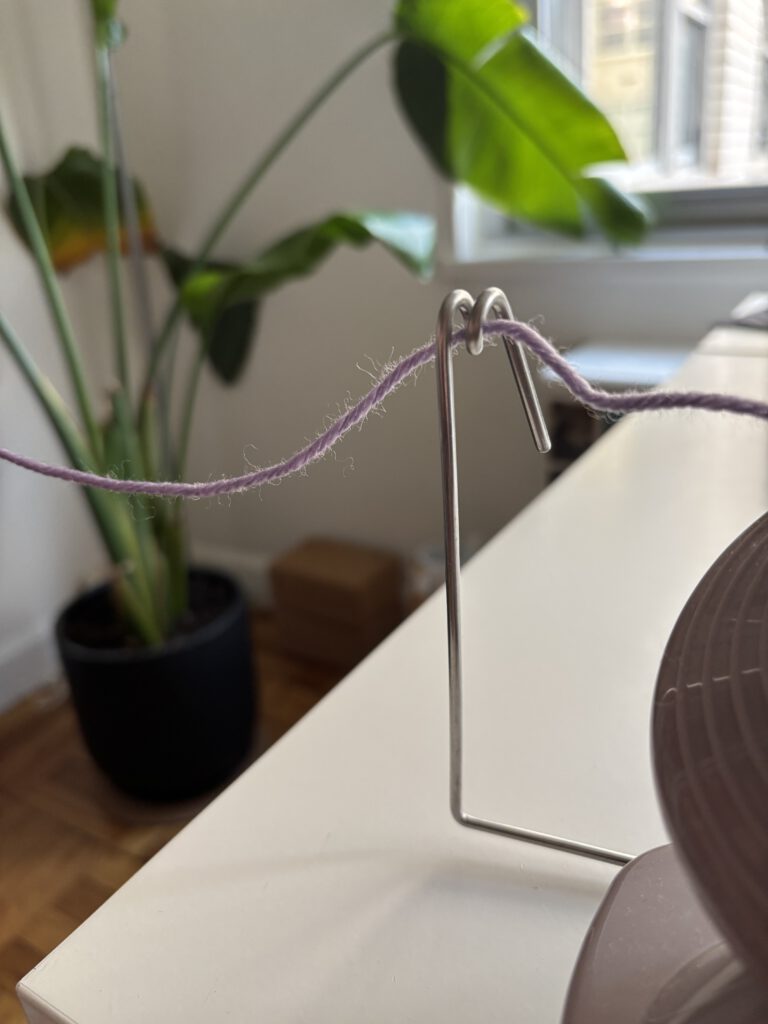 Yarn thread through a metal spiral towards a yarn winder